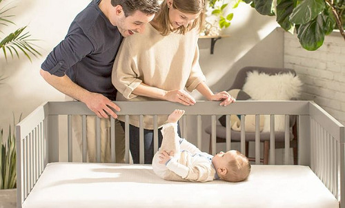 A baby sleeping in a crib