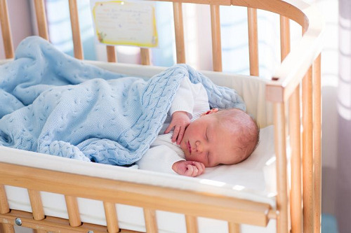 A baby sleeping in a crib